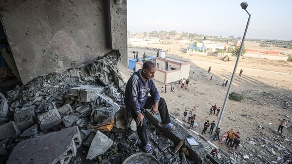 A Palestinian man cries looking at the destruction following an Israeli air strike on Hamad Town in Gaza