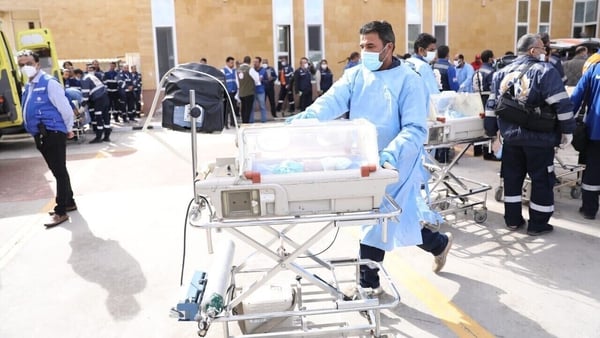 Medical staff placed the infants in mobile incubators and wheeled them across a car park towards other ambulances (Egyptian Health Ministry/Handout)
