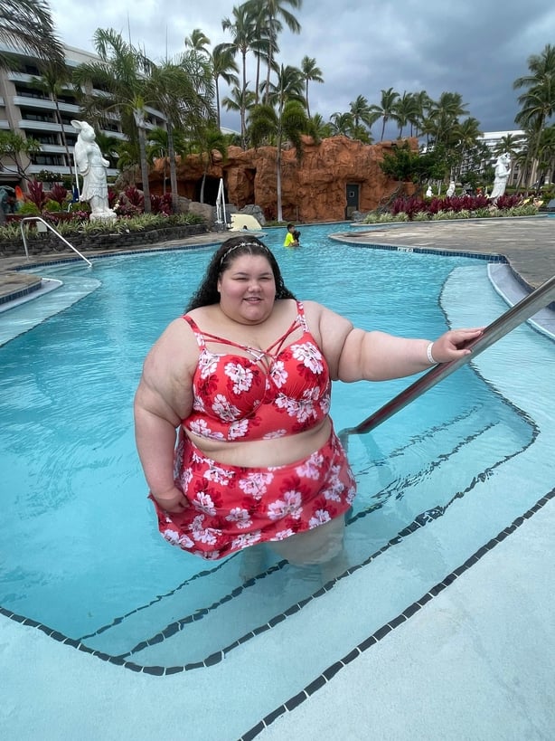 A woman climbing out of a pool at a hotel